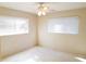 Sunlit bedroom features a ceiling fan and two large windows with bright white walls at 2155 Wood St # A26, Sarasota, FL 34237