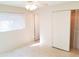 Bedroom featuring closet with sliding doors, ceiling fan and doorway to another room at 2155 Wood St # A26, Sarasota, FL 34237