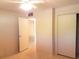 Bright bedroom features a ceiling fan, closet and doorway leading to another room at 2155 Wood St # A26, Sarasota, FL 34237