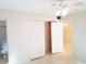 Bedroom featuring closet with sliding doors, view into bathroom, and ceiling fan at 2155 Wood St # A26, Sarasota, FL 34237