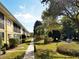 Exterior of building with manicured landscaping and lawn and walkway at 2155 Wood St # A26, Sarasota, FL 34237