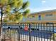 Exterior view of a well-maintained building with secure, gated access, and private balconies for each residence at 2155 Wood St # A26, Sarasota, FL 34237