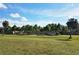 Expansive green space perfect for recreation, showcased in this community image under a sunny, partly cloudy sky at 2155 Wood St # A26, Sarasota, FL 34237