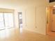 Living room with terrazzo floors and glass door leading to balcony at 2155 Wood St # A26, Sarasota, FL 34237