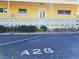Designated parking space in front of the building, highlighting convenient access for residents and well-maintained landscaping at 2155 Wood St # A26, Sarasota, FL 34237