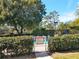Secured community pool gate surrounded by lush landscaping and signage at 2155 Wood St # A26, Sarasota, FL 34237
