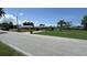 Street view of house with well-maintained lawns in a sunny neighborhood at 23067 Elmira Blvd, Punta Gorda, FL 33980