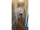 Hallway featuring wood flooring, fresh paint, and access to rooms at 23067 Elmira Blvd, Punta Gorda, FL 33980