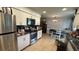 The kitchen features stainless steel appliances, and tiled floors, next to a dining space at 23067 Elmira Blvd, Punta Gorda, FL 33980
