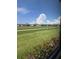 Backyard view with grass and flowers from window at 24803 Buckingham Way, Port Charlotte, FL 33980