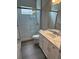 Modern bathroom featuring a glass-enclosed shower, white vanity, and marble countertops at 24803 Buckingham Way, Port Charlotte, FL 33980