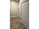 Hallway with wood floors featuring storage closet at 24803 Buckingham Way, Port Charlotte, FL 33980