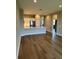 A modern kitchen view from the living area with stainless steel appliances and hardwood floors at 24803 Buckingham Way, Port Charlotte, FL 33980
