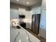 Bright kitchen featuring white cabinetry, stainless steel appliances, and white quartz countertops at 24803 Buckingham Way, Port Charlotte, FL 33980
