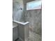 Contemporary shower with elegant gray marble tiles and a clear glass partition at 24803 Buckingham Way, Port Charlotte, FL 33980