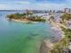 Aerial view of marina with docked boats, city skyline, and beach at 2500 Boone Ct, Sarasota, FL 34237