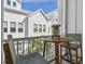Relaxing balcony with a table, two chairs, and a view of neighboring houses and greenery with a planter at 2500 Boone Ct, Sarasota, FL 34237