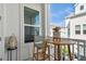 Relaxing balcony with a table, two chairs, and a view of neighboring houses with a planter at 2500 Boone Ct, Sarasota, FL 34237