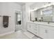 Bright bathroom features double sinks, neutral tile, and a glass enclosed shower at 2500 Boone Ct, Sarasota, FL 34237