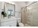 Modern bathroom with a glass-enclosed shower, a white vanity, and a large mirror at 2500 Boone Ct, Sarasota, FL 34237