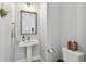 A well lit pedestal sink is the highlight of this half bath at 2500 Boone Ct, Sarasota, FL 34237