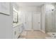 Elegant bathroom features a double vanity, neutral tile flooring, and a modern glass-enclosed shower at 2500 Boone Ct, Sarasota, FL 34237