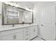 Bathroom features a dual sink vanity, a large mirror, and a walk-in shower at 2500 Boone Ct, Sarasota, FL 34237