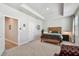 Spacious bedroom with neutral carpet, tray ceiling, walk-in closet and a cozy seating area at 2500 Boone Ct, Sarasota, FL 34237