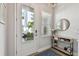Bright entryway featuring a white front door with glass and a console table with decor and a mirror at 2500 Boone Ct, Sarasota, FL 34237