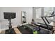 Bright home gym with work out equipment, a full sized mirror, and two windows with white blinds at 2500 Boone Ct, Sarasota, FL 34237
