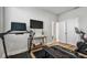 Bright home gym with work out equipment and two windows with white blinds at 2500 Boone Ct, Sarasota, FL 34237