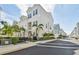 Charming townhome showcases a fenced-in patio, lush landscaping, and a well-maintained white exterior at 2500 Boone Ct, Sarasota, FL 34237