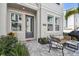 Charming townhouse features a welcoming entry, stylish patio furniture, and beautiful landscaping at 2500 Boone Ct, Sarasota, FL 34237