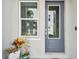 Stylish front door with a window, potted plants, and a modern exterior creates a welcoming entry at 2500 Boone Ct, Sarasota, FL 34237