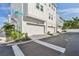 View of the garages showing the clean design, crosswalk, and street sign in the neighborhood at 2500 Boone Ct, Sarasota, FL 34237