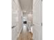 Neutral hallway with wood floors and white doors creates a clean transition between living spaces at 2500 Boone Ct, Sarasota, FL 34237