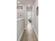Bright hallway features wood floors, fresh paint and trim, leading to bedrooms filled with natural light at 2500 Boone Ct, Sarasota, FL 34237