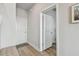 Hallway featuring wood floors, white doors, gray walls, and white trim with a decorative rug and hallway bench at 2500 Boone Ct, Sarasota, FL 34237