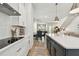 Modern kitchen boasts white cabinetry, stainless steel appliances, and an island with counter seating at 2500 Boone Ct, Sarasota, FL 34237