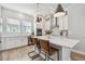 Modern kitchen featuring a central island with seating, stainless steel appliances, and white cabinetry at 2500 Boone Ct, Sarasota, FL 34237