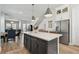 Open kitchen and dining area with a center island, stainless appliances, and wood floors at 2500 Boone Ct, Sarasota, FL 34237