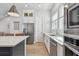 Modern kitchen displays stainless appliances, white cabinets, quartz counters, hardwood floors, and natural lighting at 2500 Boone Ct, Sarasota, FL 34237
