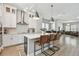 Open kitchen with a center island and barstool seating, leading into a living area at 2500 Boone Ct, Sarasota, FL 34237