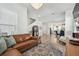 Open-concept living space with a cozy leather sectional and views of the adjacent kitchen at 2500 Boone Ct, Sarasota, FL 34237
