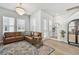 Inviting living room with a leather sectional, stylish rug, and ample natural light at 2500 Boone Ct, Sarasota, FL 34237