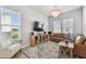 Inviting living room with a leather sectional, stylish rug, and ample natural light at 2500 Boone Ct, Sarasota, FL 34237