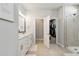 Modern main bathroom with dual sinks, walk-in shower, and access to a walk-in closet at 2500 Boone Ct, Sarasota, FL 34237