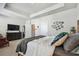 Well-appointed main bedroom with neutral tones, a king bed, a TV, and decorative wall art at 2500 Boone Ct, Sarasota, FL 34237