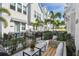 Charming patio space with a brick surface, surrounded by lush landscaping and a stylish outdoor seating area at 2500 Boone Ct, Sarasota, FL 34237