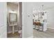 View of powder room with pedestal sink and decorative tile floors, adjacent to open kitchen at 2500 Boone Ct, Sarasota, FL 34237